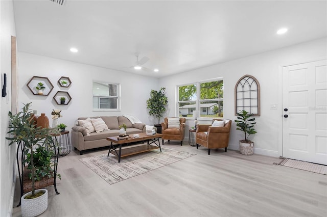 living room featuring light hardwood / wood-style flooring and ceiling fan