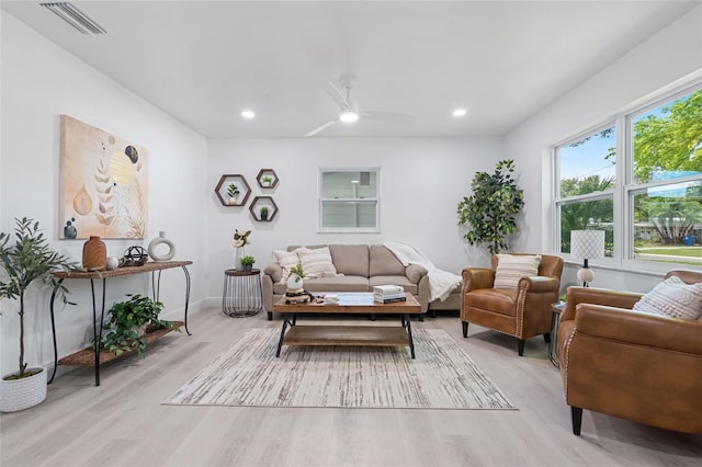 living room with ceiling fan and light hardwood / wood-style flooring