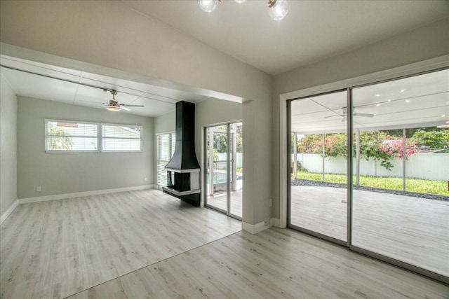 interior space with ceiling fan and light hardwood / wood-style flooring