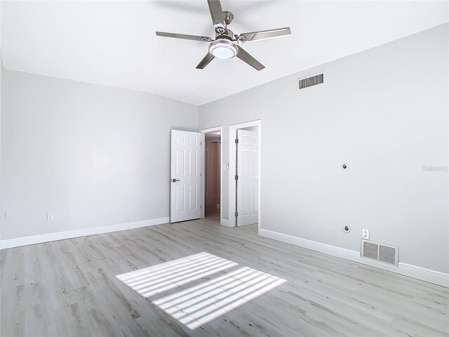 unfurnished room with light wood-type flooring and ceiling fan