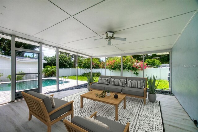 sunroom featuring ceiling fan