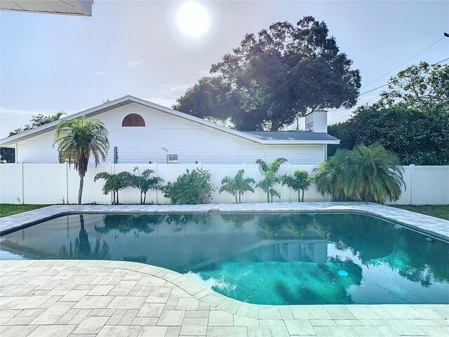 view of swimming pool featuring a patio area, a fenced backyard, and a fenced in pool