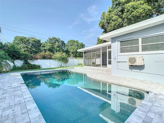 view of swimming pool with cooling unit and a patio area