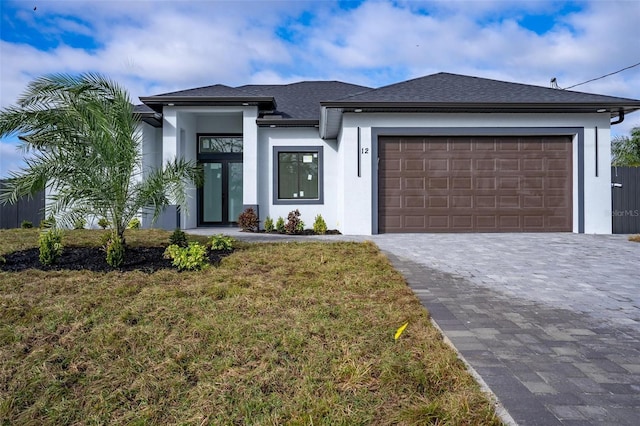 view of front of property with a garage and a front yard