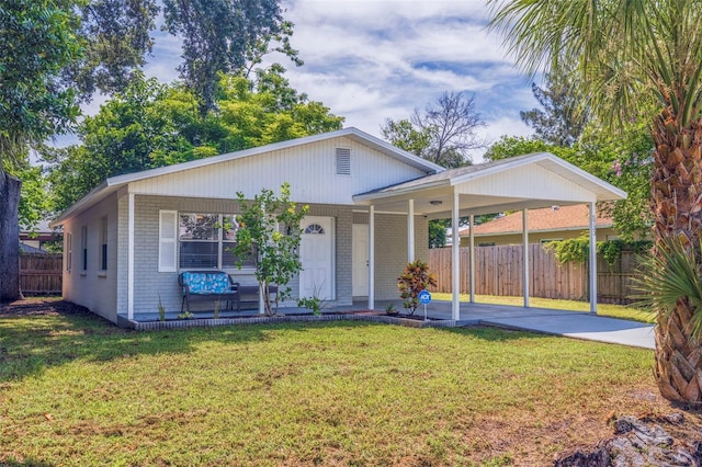 view of front of home featuring a carport, covered porch, and a front yard