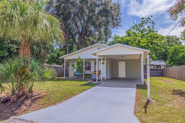 view of front facade with a front lawn and a carport