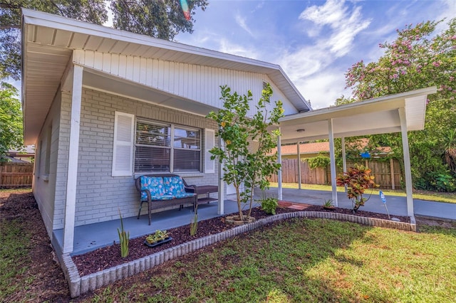 view of front of property featuring a carport and a porch