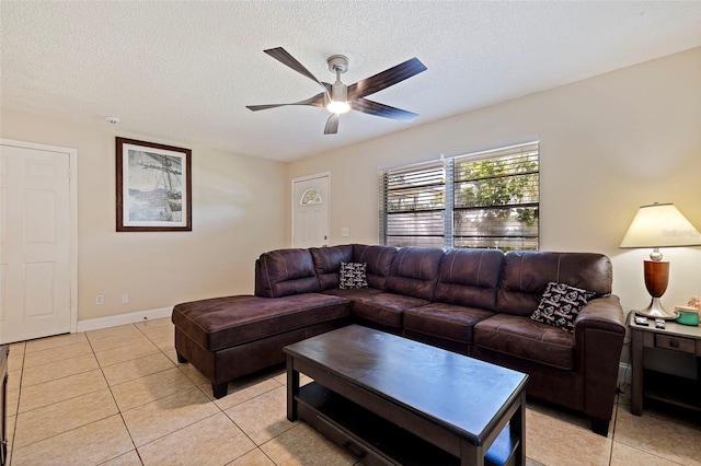 tiled living room featuring a textured ceiling and ceiling fan