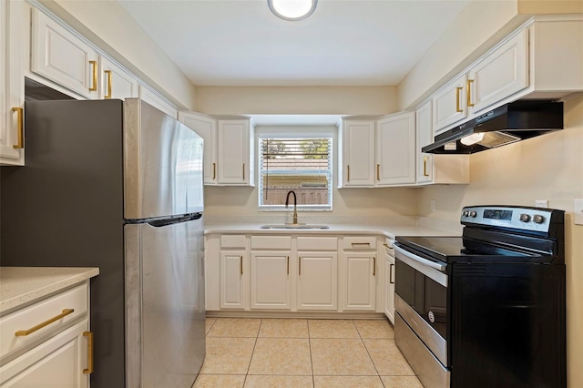 kitchen with sink, stainless steel appliances, light tile patterned floors, and white cabinetry