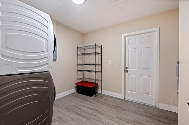 5733 66th Ln N, Saint Petersburg, FL 33709 - interior space with stacked washer and dryer and light hardwood / wood-style flooring