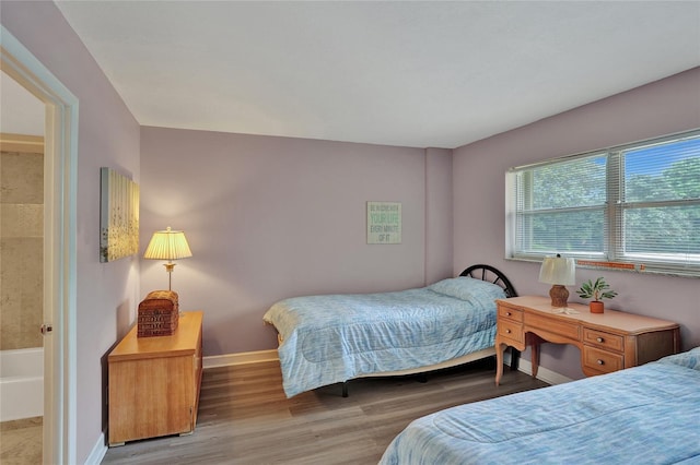 bedroom with hardwood / wood-style flooring