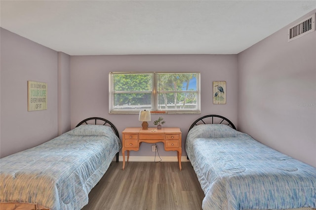 bedroom with dark hardwood / wood-style floors