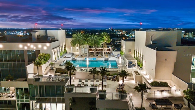 outdoor building at dusk with a community pool