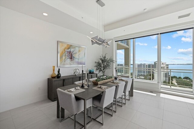 tiled dining area with a water view