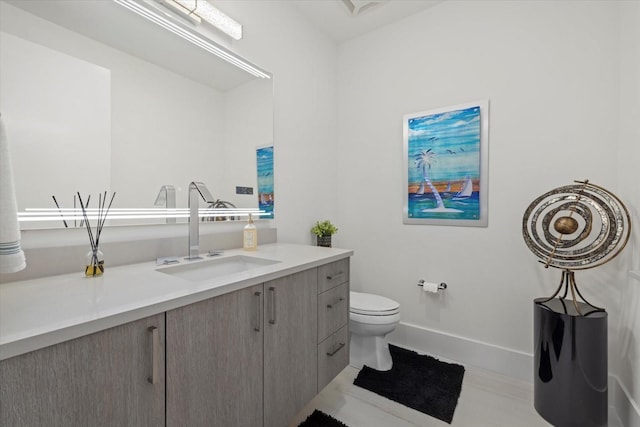 bathroom with vanity, toilet, and tile patterned flooring