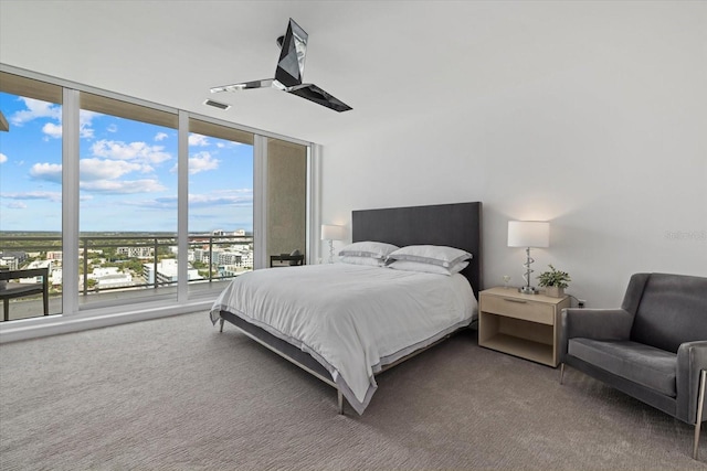 bedroom with ceiling fan, multiple windows, and carpet