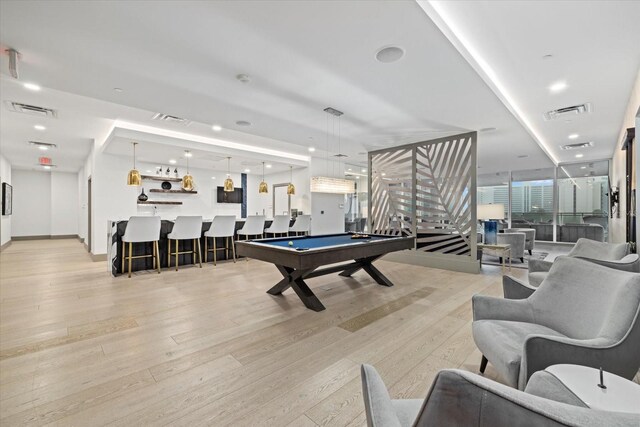 playroom featuring pool table, a wall of windows, and light hardwood / wood-style floors