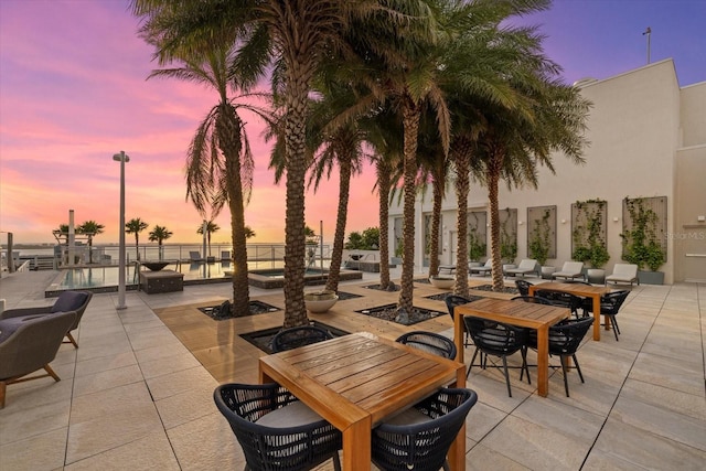 patio terrace at dusk with a water view