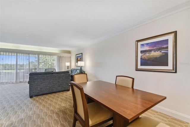 carpeted dining space featuring ornamental molding