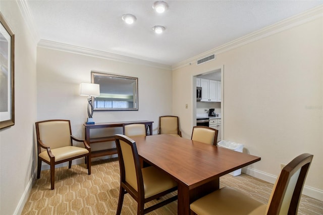 dining space featuring light carpet and crown molding