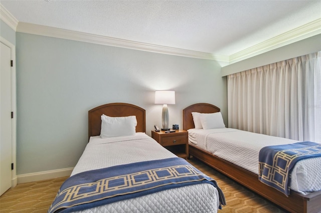 bedroom with crown molding and a textured ceiling