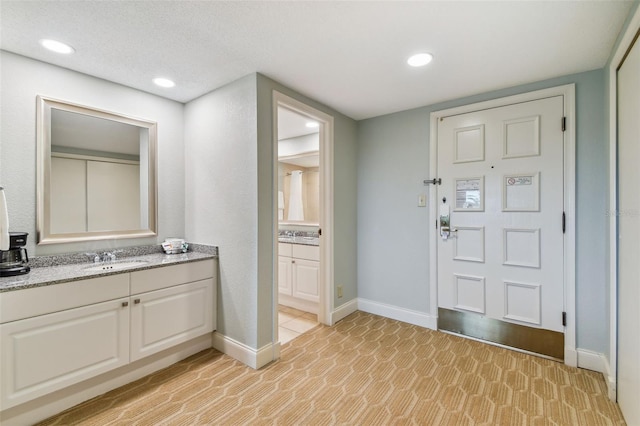 interior space with sink and a textured ceiling