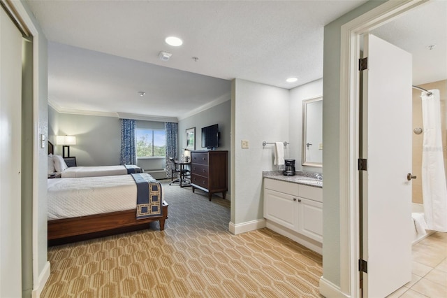 carpeted bedroom featuring ornamental molding and sink