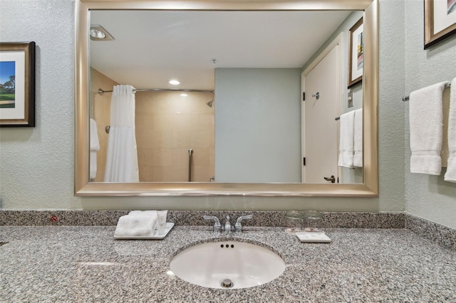 bathroom featuring vanity and walk in shower