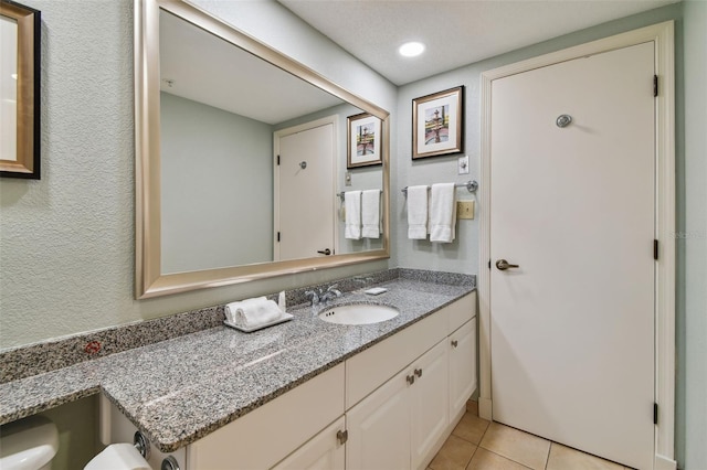 bathroom with tile patterned floors and vanity