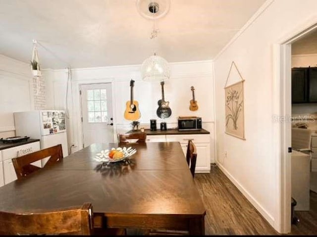 dining space with crown molding and hardwood / wood-style floors