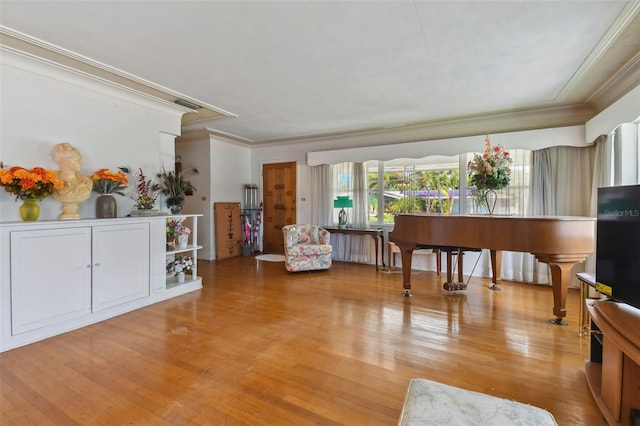 living area with ornamental molding and light wood-type flooring