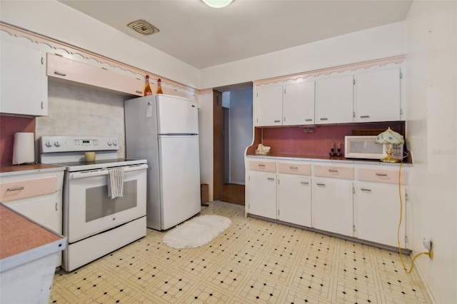 kitchen featuring white appliances and white cabinets