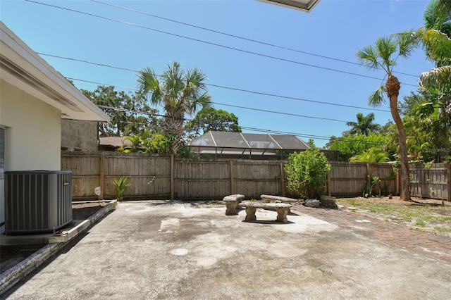 view of patio / terrace featuring cooling unit and glass enclosure