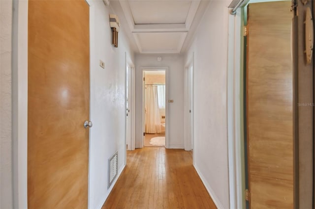 hall featuring hardwood / wood-style flooring and ornamental molding