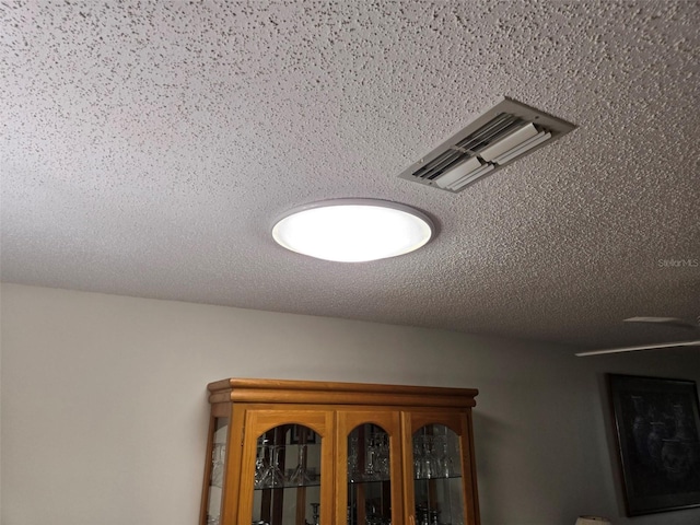 room details with a textured ceiling and visible vents