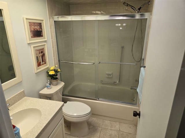 bathroom with toilet, enclosed tub / shower combo, vanity, and tile patterned floors