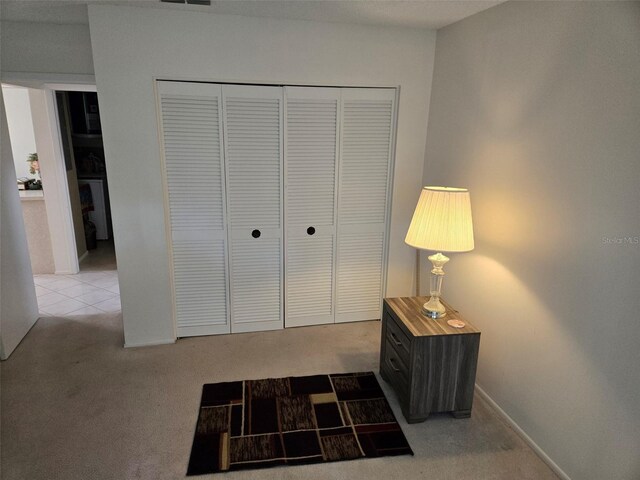 carpeted bedroom with a closet