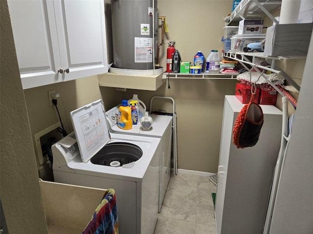 laundry area featuring cabinet space, washing machine and dryer, light tile patterned floors, and gas water heater