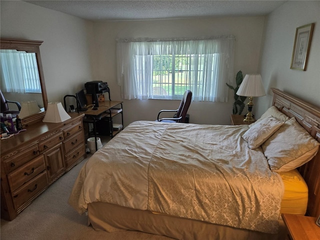 bedroom featuring light carpet and a textured ceiling