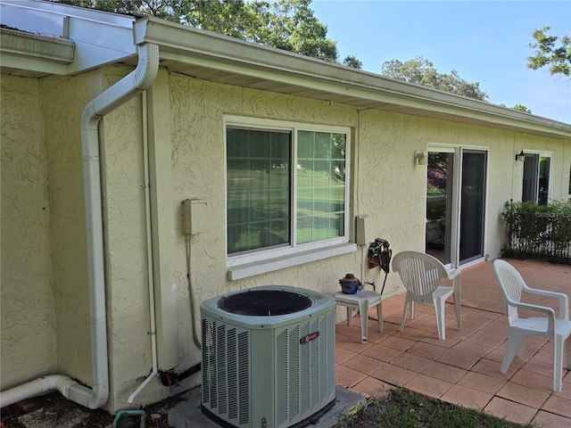 exterior space featuring a patio and cooling unit