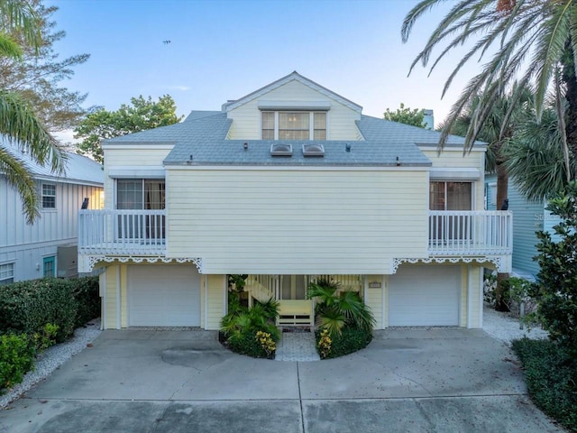 view of front of home featuring a balcony and a garage