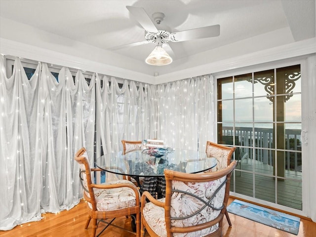 dining space with ceiling fan and hardwood / wood-style floors