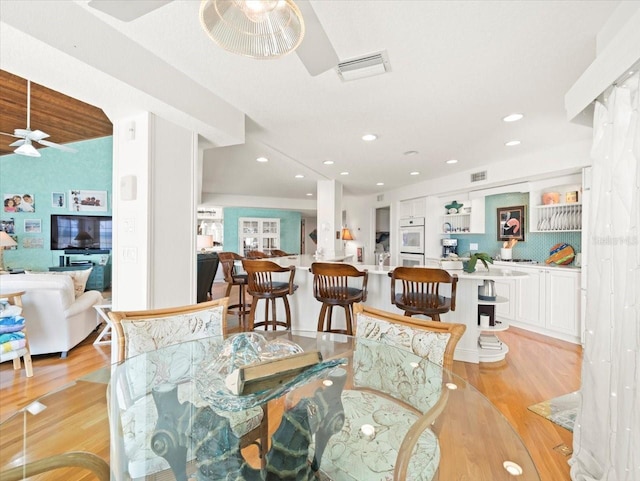 dining room featuring light hardwood / wood-style flooring and ceiling fan