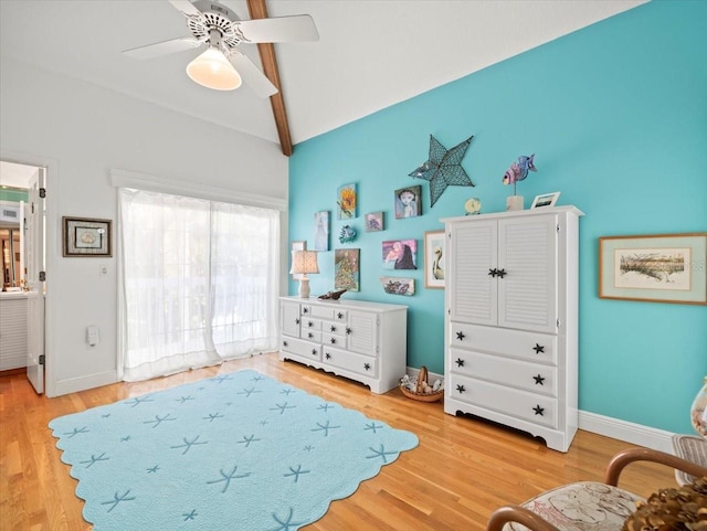 bedroom featuring lofted ceiling with beams, ceiling fan, and light wood-type flooring