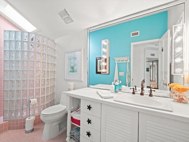 bathroom with tile patterned flooring, toilet, and vanity