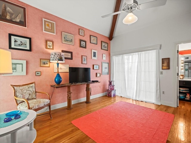 interior space with lofted ceiling with beams, ceiling fan, and light wood-type flooring