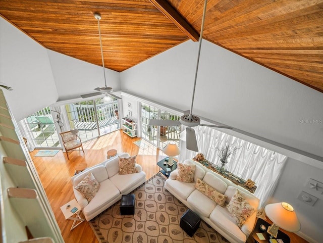 living room with ceiling fan, hardwood / wood-style flooring, lofted ceiling with beams, and wooden ceiling