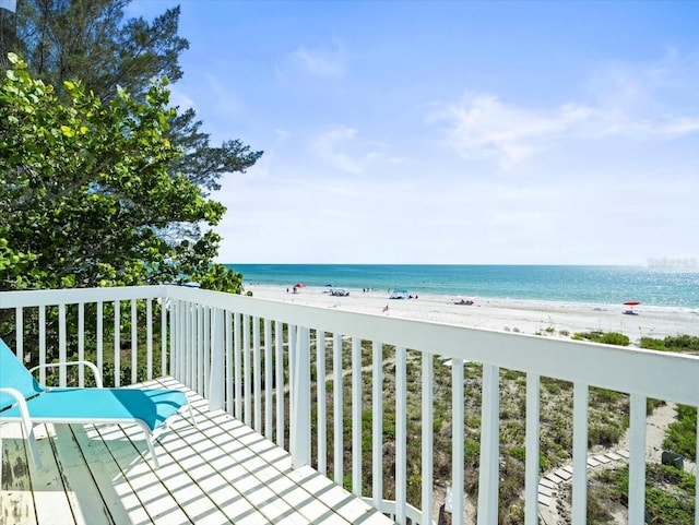 balcony featuring a water view and a view of the beach