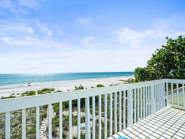 balcony featuring a water view and a view of the beach