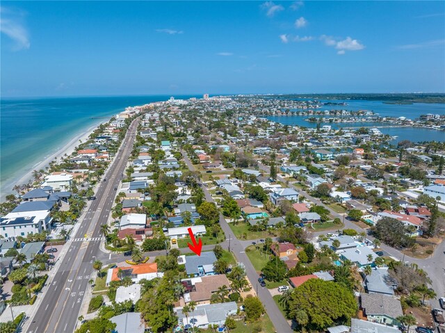 birds eye view of property with a water view and a view of the beach